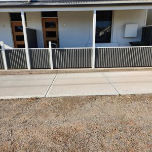 a sidewalk in front of a house with a fence at City Villa 39 Blende st Broken Hill NSW 2880 in Broken Hill