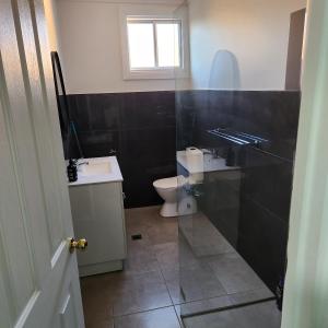 a bathroom with a sink and a toilet at City Villa 39 Blende st Broken Hill NSW 2880 in Broken Hill