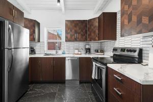 a kitchen with wooden cabinets and stainless steel appliances at The Creekstone in Idyllwild