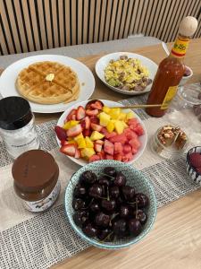 a table with plates of food on a table at SunStar Alaska Bed and Breakfast LLC in Anchorage