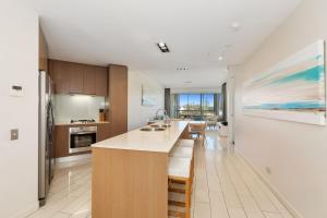 a kitchen with a large island in a room at Wave Culture 1204 Beach Bliss - Apartment with complex Pool & Spa in Kingscliff