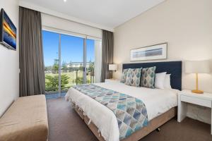 a bedroom with a large bed and a large window at Wave Culture 1204 Beach Bliss - Apartment with complex Pool & Spa in Kingscliff +16 photos