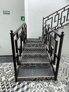 a staircase in a room with a tile floor at Casa Sol in Oaxaca City