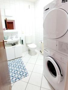 a white bathroom with a washing machine in it at Essen-Steele, 2-Zimmer, 4 Person in Essen