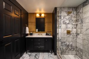 a bathroom with a sink and a shower at Victoria 1883 in New Smyrna Beach