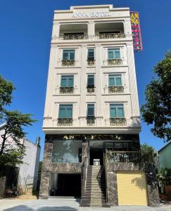 a white building with stairs in front of it at Anna Hotel Binh Duong in Bến Cát