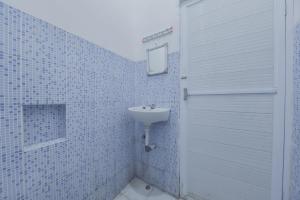 a bathroom with a sink and a mirror at Reddoorz near Juwata Airport Tarakan in Tarakan