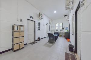 an empty room with a hallway with desks and chairs at Reddoorz near Juwata Airport Tarakan in Tarakan
