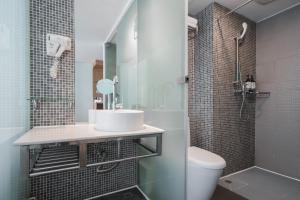 a bathroom with a sink and a shower and a toilet at Shanshui Trends Hotel - Huaqiangbei in Shenzhen