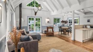 a living room with a couch and a table at Dove Cottage in Bundanoon
