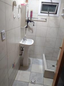 a small bathroom with a sink and a toilet at Los alamos in Río Gallegos