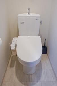 a bathroom with a white toilet in a room at Apartment Hotel 11 Namba-Minami Ebisucho-Eki Mae in Osaka