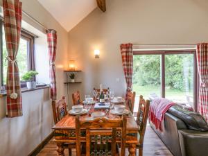 a dining room with a table and a couch at Farrow in Scarborough