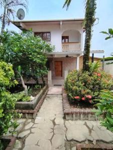 a house with a walkway in front of it at Casa de Rojo 3 Bedroom house with private Pool and all amenities in Bocas del Toro
