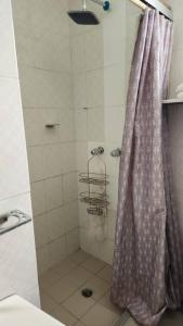 a shower with a shower curtain in a bathroom at Casa de Rojo 3 Bedroom house with private Pool and all amenities in Bocas del Toro