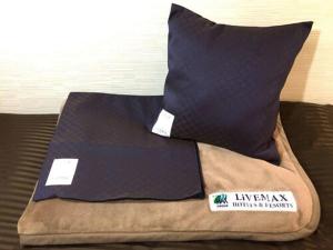 Łóżko lub łóżka w pokoju w obiekcie HOTEL LiVEMAX BUDGET Nagoya Taikodori