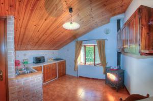 a kitchen with a sink and a stove at Appartamenti De Sanctis in Villetta Barrea