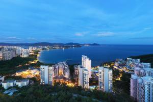 a city with buildings and a body of water at Ascott Dadonghai Bay Sanya in Sanya