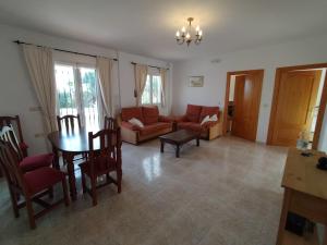 a living room with a table and a couch at CASA ÁNGEL LAS LABORES ALBOX in Albox