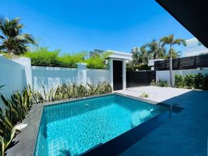 a swimming pool in the backyard of a house at Palm Oasis Pool Villa by Pattaya Holiday in Jomtien Beach