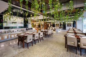 a restaurant with wooden tables and chairs and lights at Maoming International Hotel in Maoming