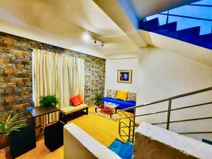 a living room with a brick wall at Hotel Dorset in Negombo