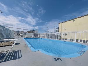 a large swimming pool in front of a building at Dry Dock Motel in Seaside Heights