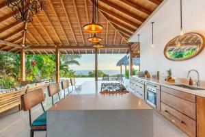 an open kitchen with a view of the ocean at Casa la Onda in Santa Teresa Beach