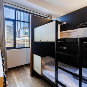 a room with two bunk beds with a window at Bunk Brisbane in Brisbane