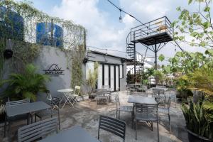 a patio with tables and chairs in a restaurant at RedDoorz near Puri Indah Lippo Mall 2 in Jakarta
