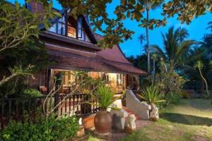 a house with palm trees in front of it at Five Islands Beach House Samui in Amphoe Koksamui