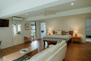 a living room with a bed and a couch at Blackwattle Farm in Beerwah
