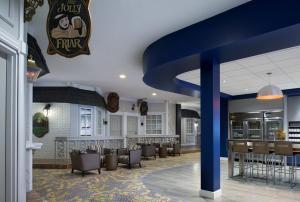 a restaurant with a bar with a blue ceiling at Saskatoon Inn & Conference Centre in Saskatoon