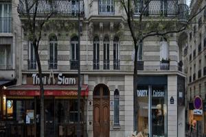 a building on a street with trees in front of it at Arc de Triomphe Superbe Appartement Paris in Paris