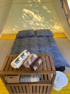 a bed in a tent with pillows on it at Na vrtu K25 in Gradac