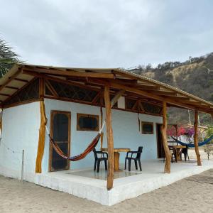 una pequeña casa con mesa y sillas en Jardin Pacifico, en Canoa