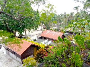a view of a resort with trees and flowers at Vatupau Beachfront Bungalows in Port Vila