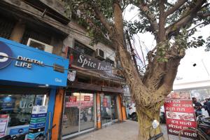 a tree standing in front of a store at OYO Hotel Supreet in Raipur