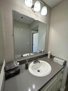 a bathroom with a sink and a large mirror at Universal Studios 8 min drive Two bedroom Apartment with free parking in Los Angeles