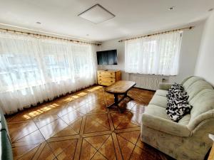 a living room with a couch and a table at Wellness Aqua House in Prague