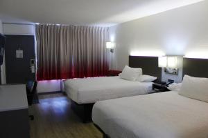 a hotel room with two beds and a window at Ramada by Wyndham Harrisonburg in Harrisonburg