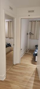 a room with white walls and a wooden floor at 2 double bedrooms apartment near airport & town in Dublin