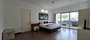 een slaapkamer met een bed en een groot raam bij The Trawangan Resort in Gili Trawangan