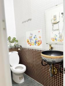 a bathroom with a toilet and a sink at Homestay Ms. Hoa in Ho Chi Minh City