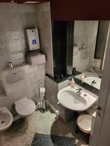 a bathroom with a sink and a toilet and a mirror at Apartament Paradise in Międzyzdroje +43 photos