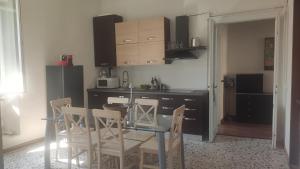 a kitchen with a glass table and chairs and a counter at Casa vacanze in centro in Lecco