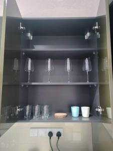 a shelf with some glass items on it at 8 Kia Peng Suites Residence in Kuala Lumpur
