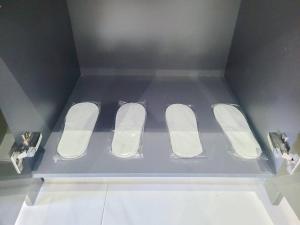 a blue box with three white slippers in a room at 8 Kia Peng Suites Residence in Kuala Lumpur