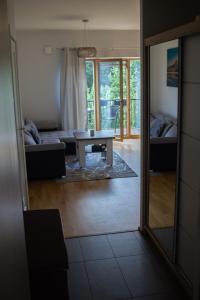 a living room with a table and a couch at Isco Apartment in Kuressaare