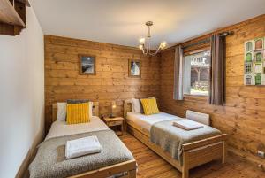 twee bedden in een kamer met houten wanden bij Apartment Villa Vallet 1, Alpes Travel, Chamonix Old Town, Sleeps 6 in Chamonix-Mont-Blanc